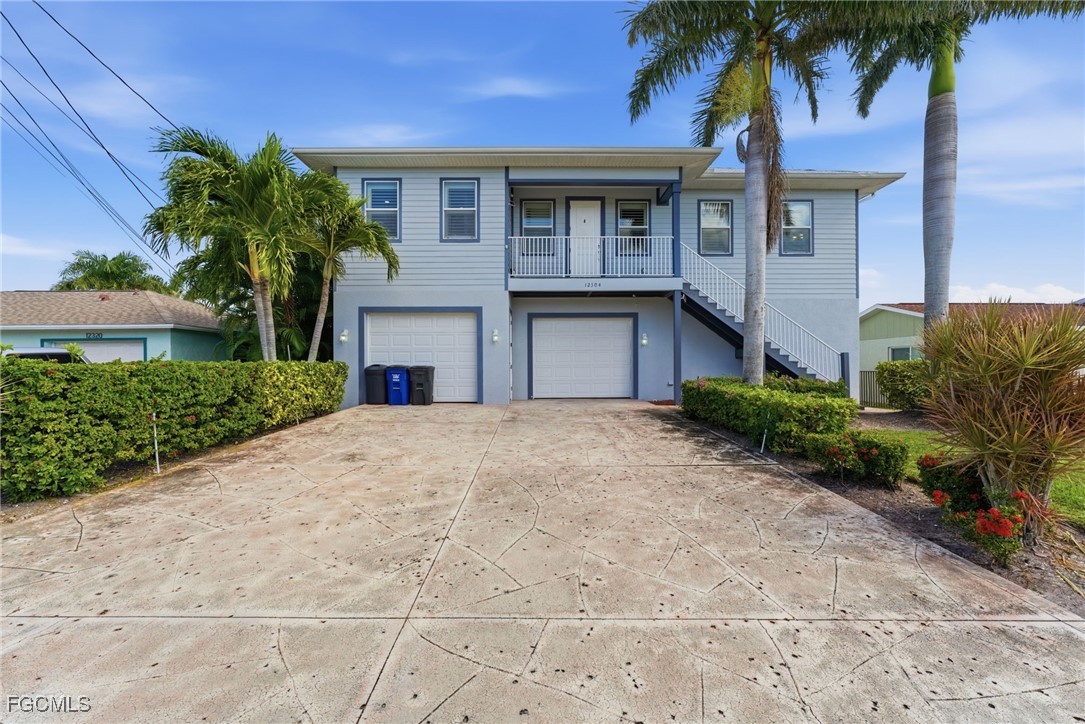 12304 Boat Shell Drive Matlacha Isles, FL 33991 - Photo 4 of 49 a house with palm tree in front of it