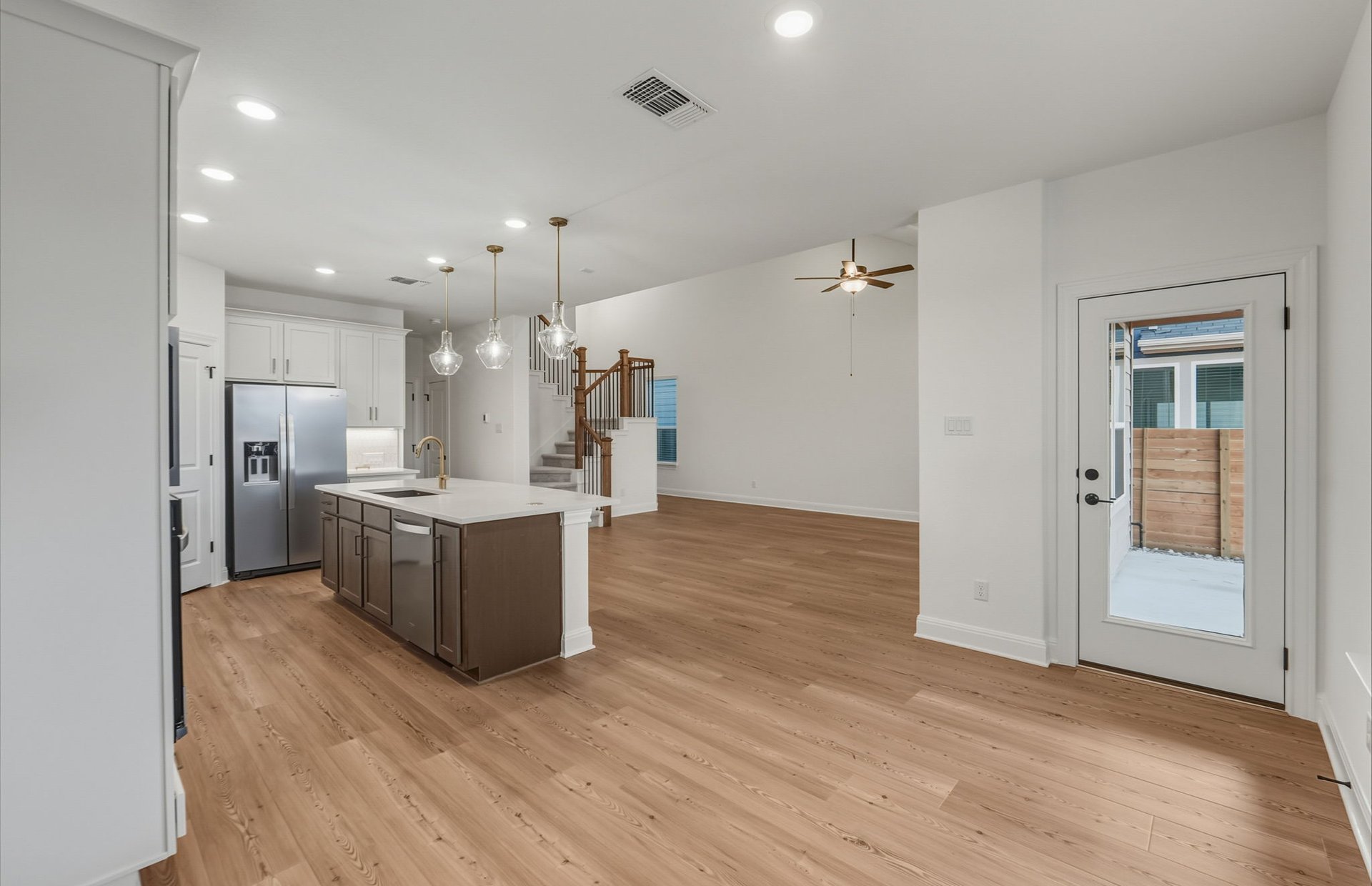 456 Foresail Road Leander, TX 78641 - Photo 6 of 22 an open kitchen with a refrigerator and a sink