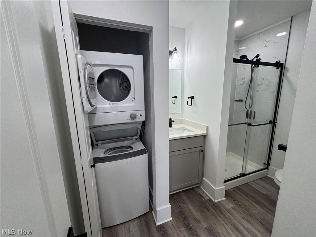 4115 Whitman Avenue, Unit UP Cleveland, OH 44113 - Photo 12 of 12 Bathroom featuring vanity, a marble finish shower, dark wood-style floors, and stacked washer / drying machine