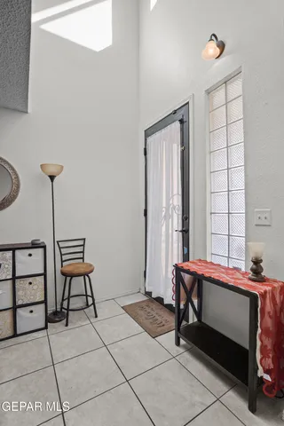 a view of a dining room and kitchen with furniture and a fan