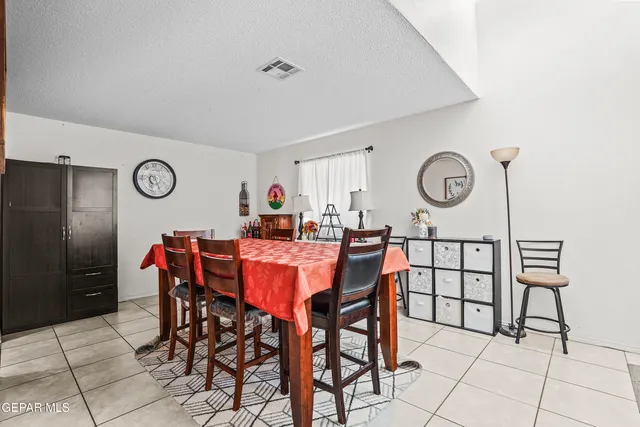 a view of a dining room with furniture and a chandelier