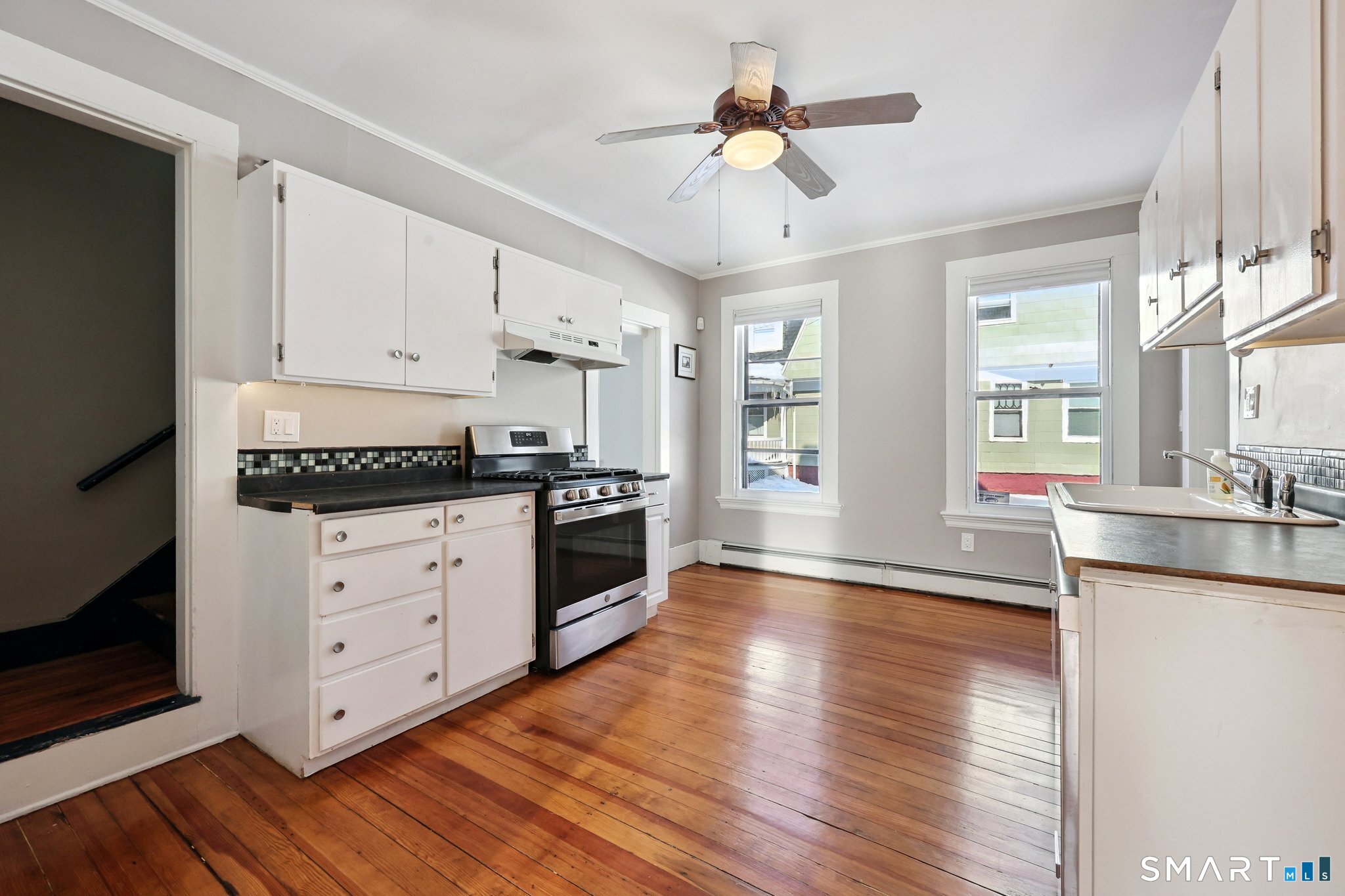 56 Whitney Street Hartford, CT 06105 - Photo 16 of 40 a kitchen with granite countertop a stove cabinets and wooden floor
