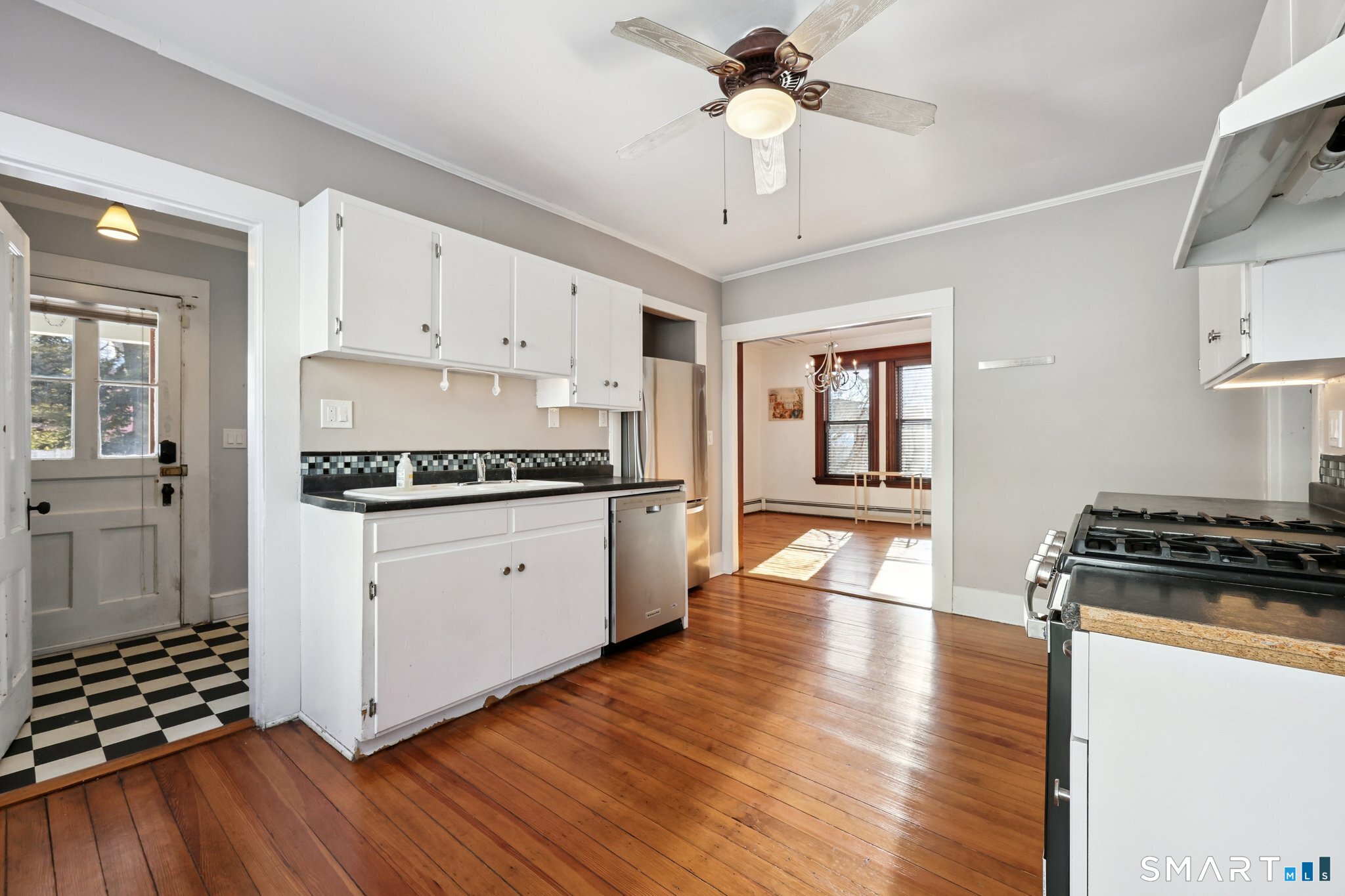 56 Whitney Street Hartford, CT 06105 - Photo 18 of 40 a kitchen with granite countertop stainless steel appliances a stove and wooden floor