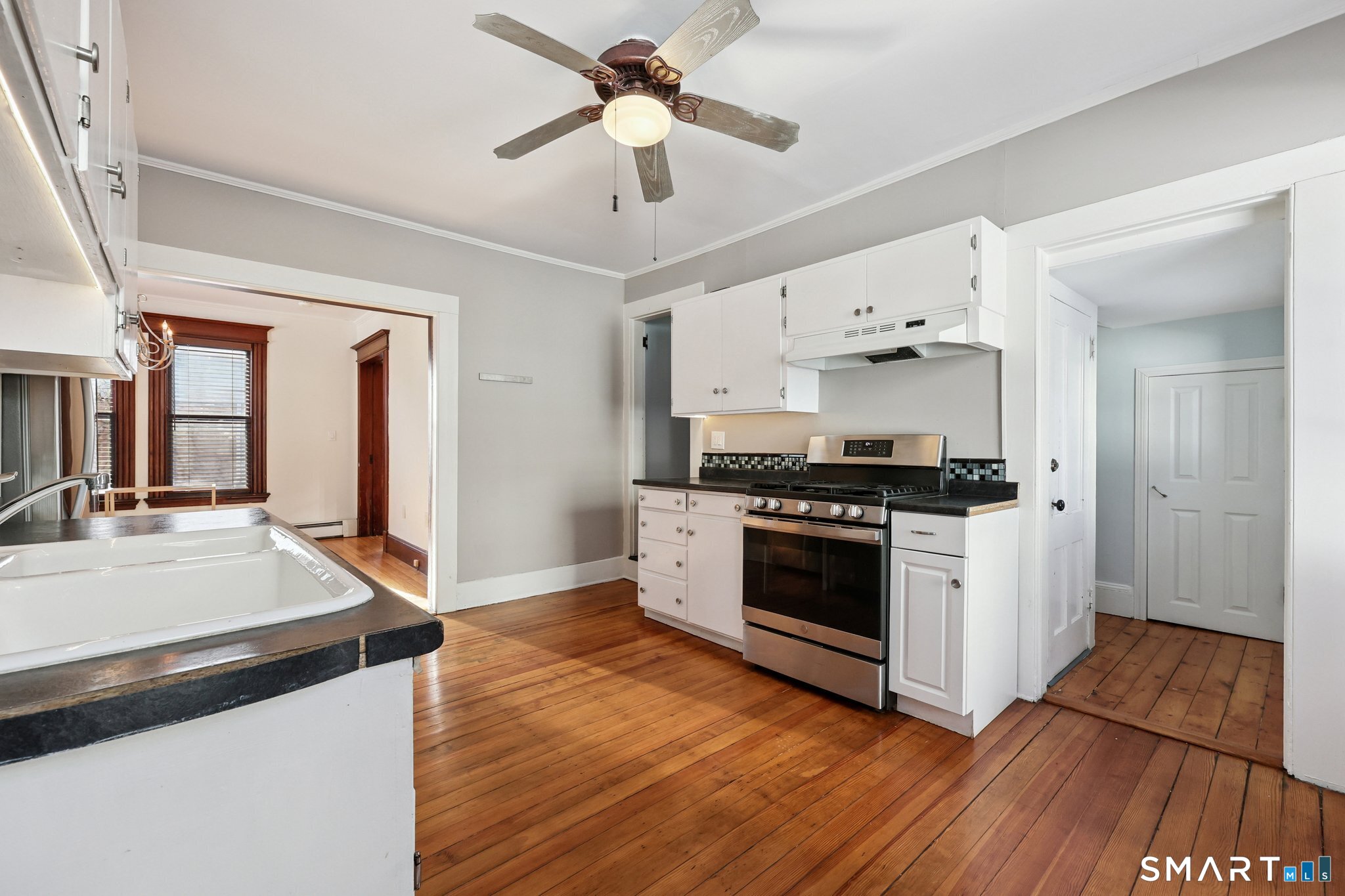 56 Whitney Street Hartford, CT 06105 - Photo 19 of 40 a kitchen with stainless steel appliances a stove a sink and a refrigerator