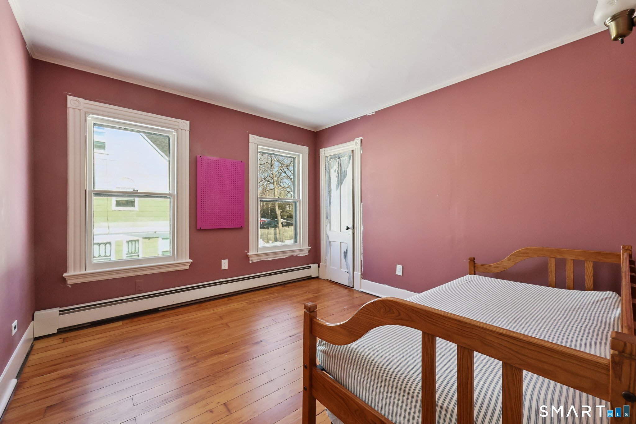 56 Whitney Street Hartford, CT 06105 - Photo 32 of 40 a bedroom with a bed and wooden floor