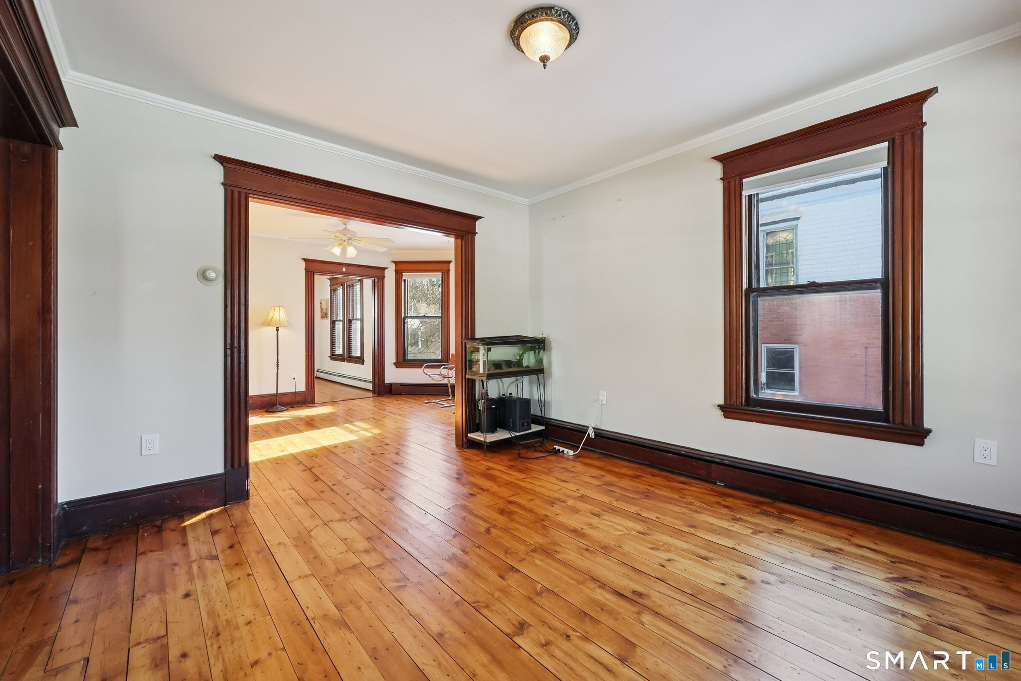 56 Whitney Street Hartford, CT 06105 - Photo 9 of 40 a view of an empty room with wooden floor and a window