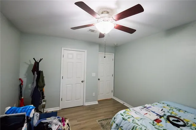 a view of bedroom with furniture and wooden floor