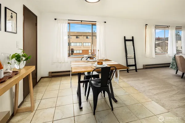 a view of a dining room with furniture and a window
