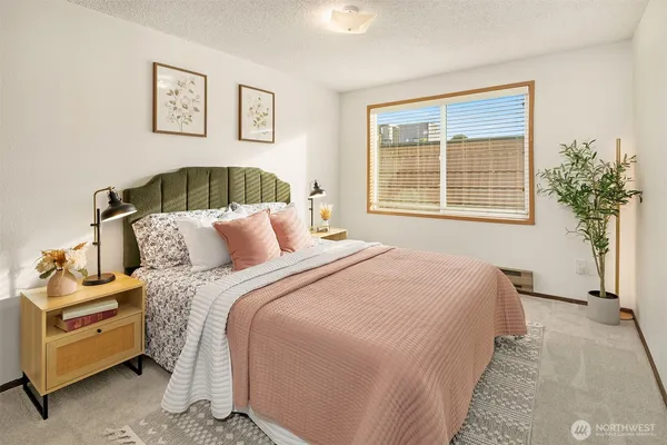 a bedroom with bed and a window
