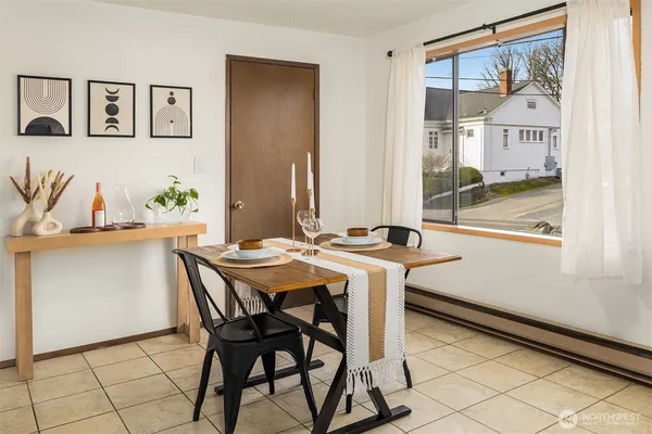 a view of a dining room with furniture and a large window