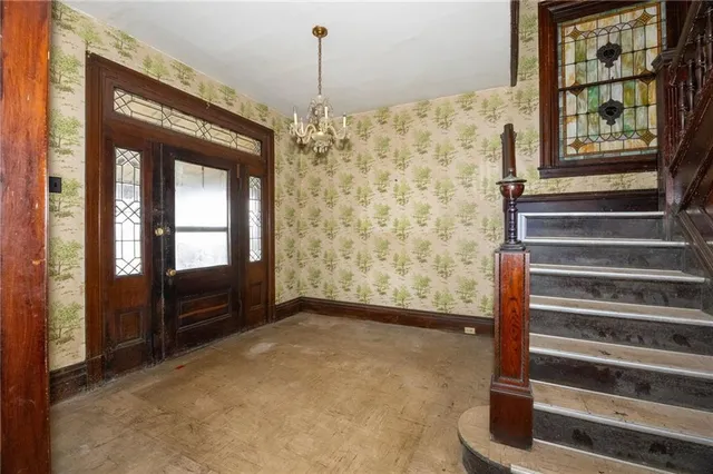 a view of an empty room with a fireplace and a window