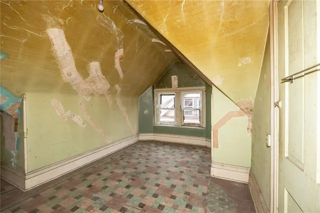 a brick building with a bench in front of it