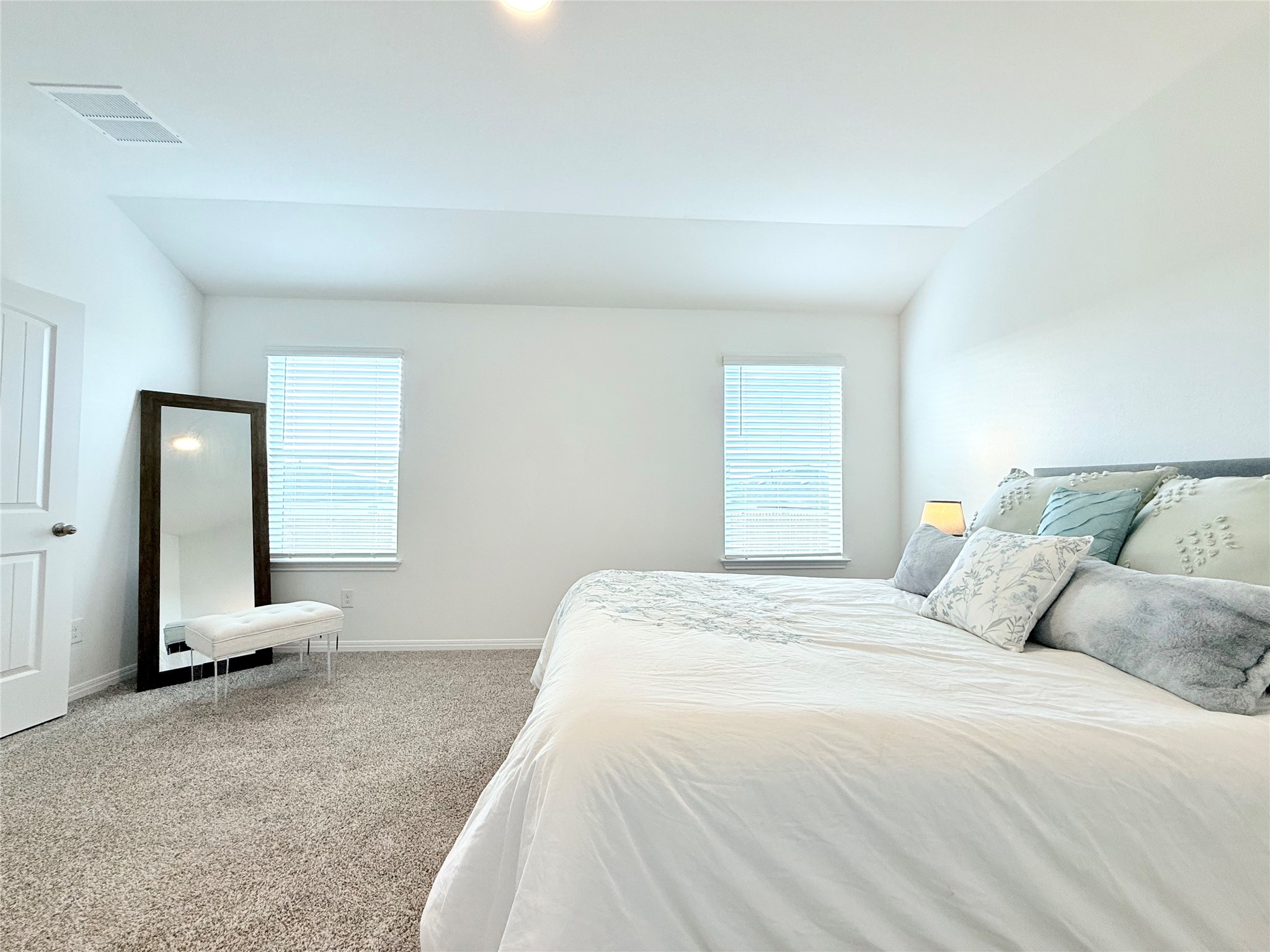 598 Gladiola Loop Kyle, TX 78640 - Photo 21 of 33 Carpeted bedroom featuring lofted ceiling and multiple windows