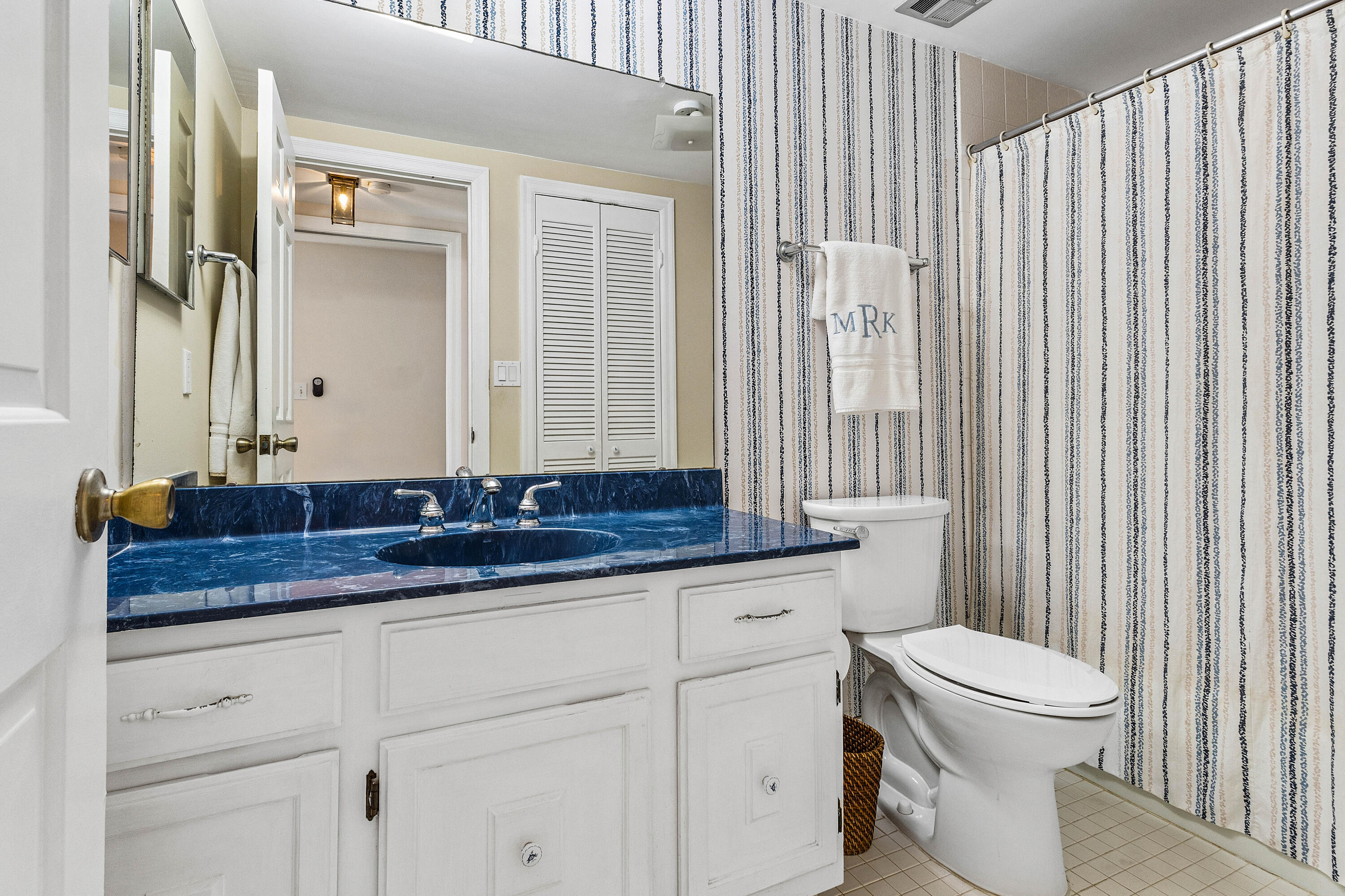 5900 Old Ocean Boulevard, Unit C5 Ocean Ridge, FL 33435 - Photo 13 of 17 a bathroom with a granite countertop sink and a toilet