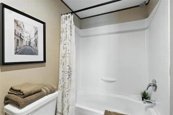 a bathroom with a shower and a bathtub