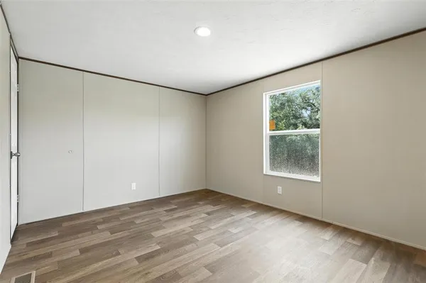 an empty room with windows and closet