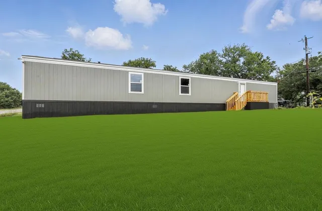 a view of front of house with a yard