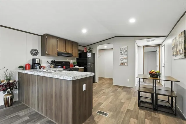 a kitchen with stainless steel appliances granite countertop a stove and a refrigerator