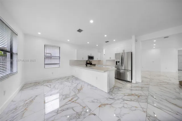 a white toilet sitting next to a white curtain