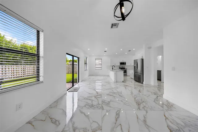 wooden floor in an empty room with a bathroom