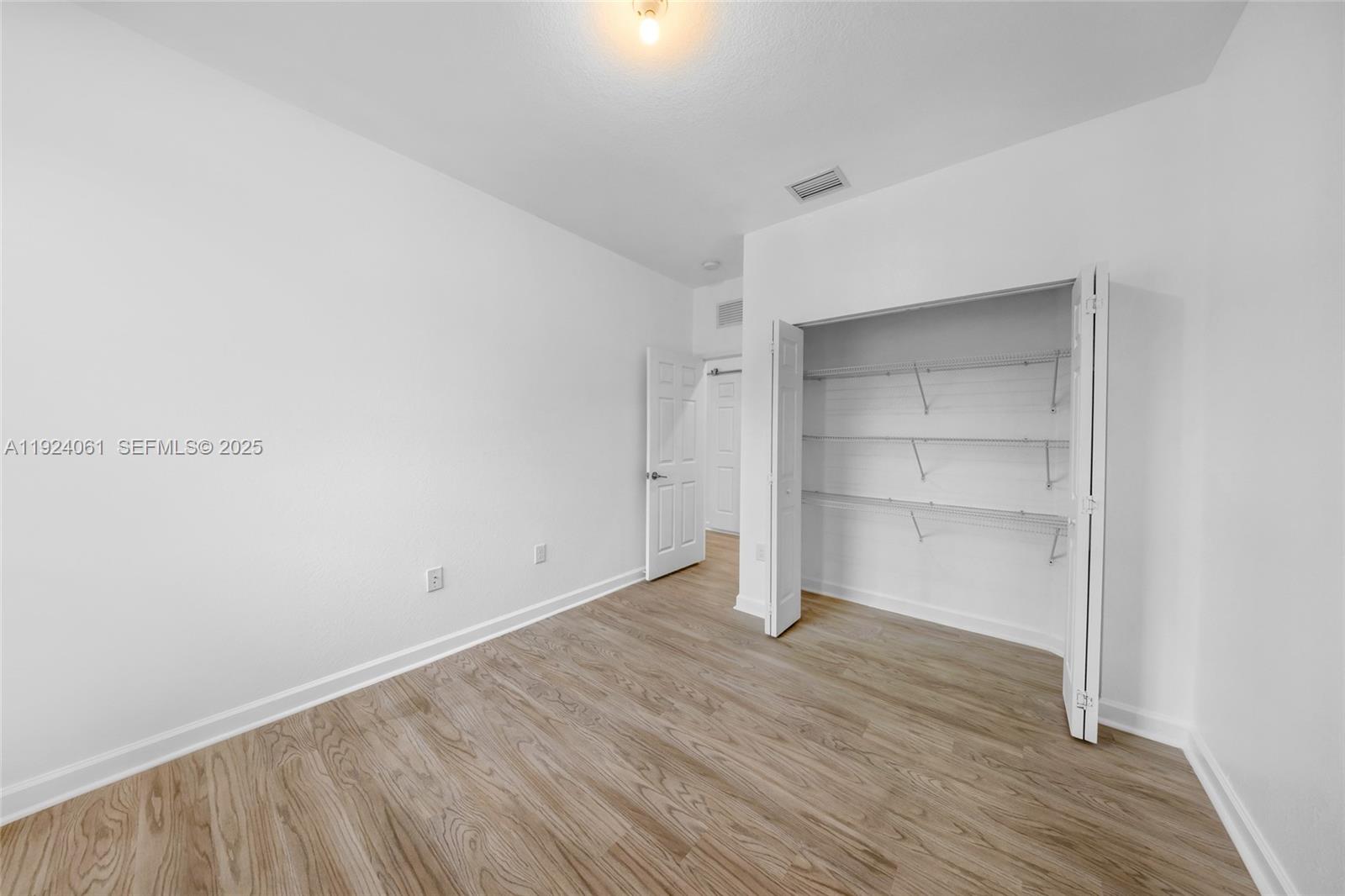 268 Northeast 210th Way Miami, FL 33179 - Photo 38 of 98 a view of an empty room with wooden floor