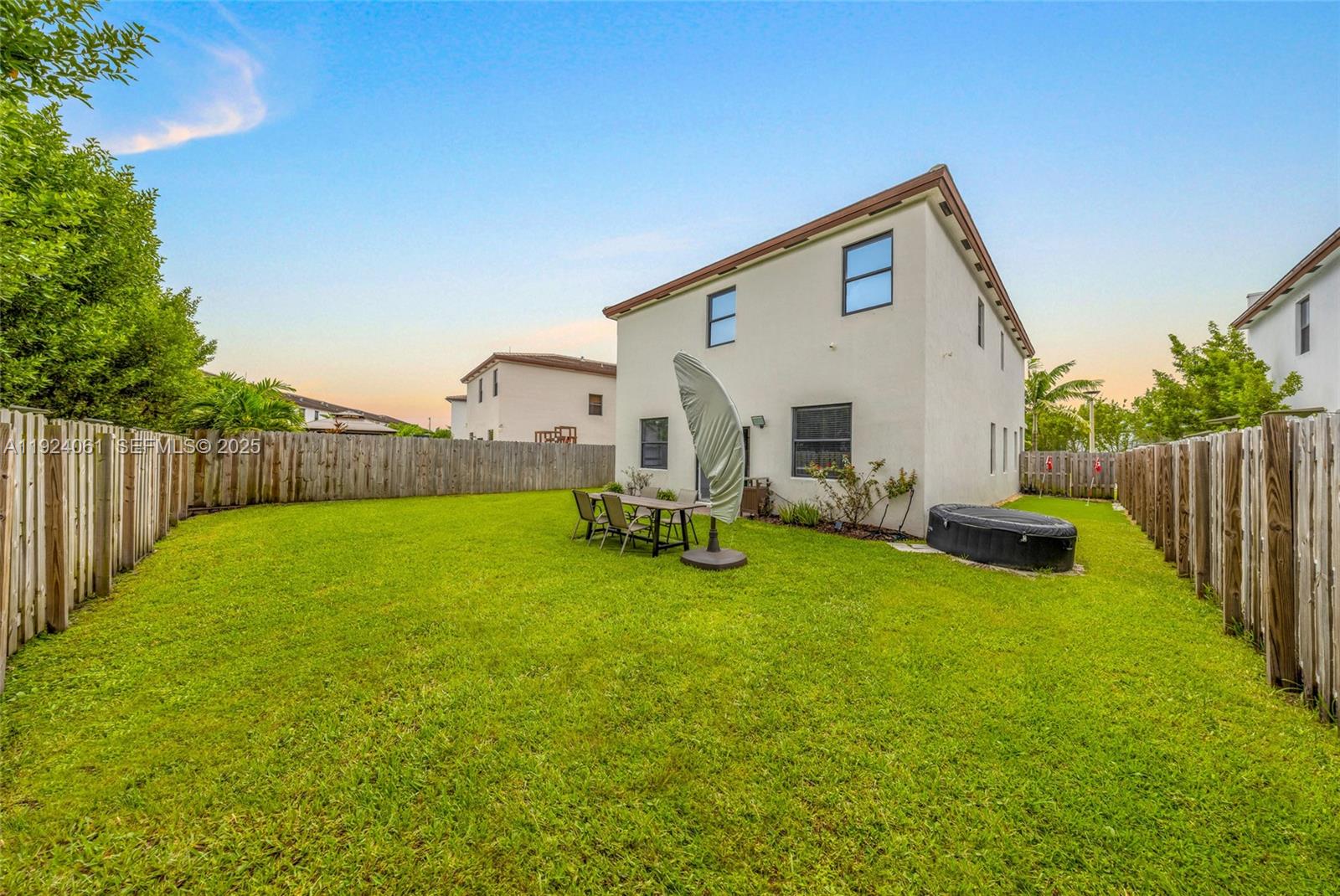 268 Northeast 210th Way Miami, FL 33179 - Photo 61 of 98 a view of a house with backyard and sitting area
