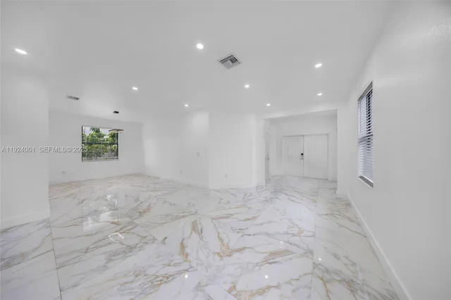 a kitchen with stainless steel appliances granite countertop a sink and a white cabinets