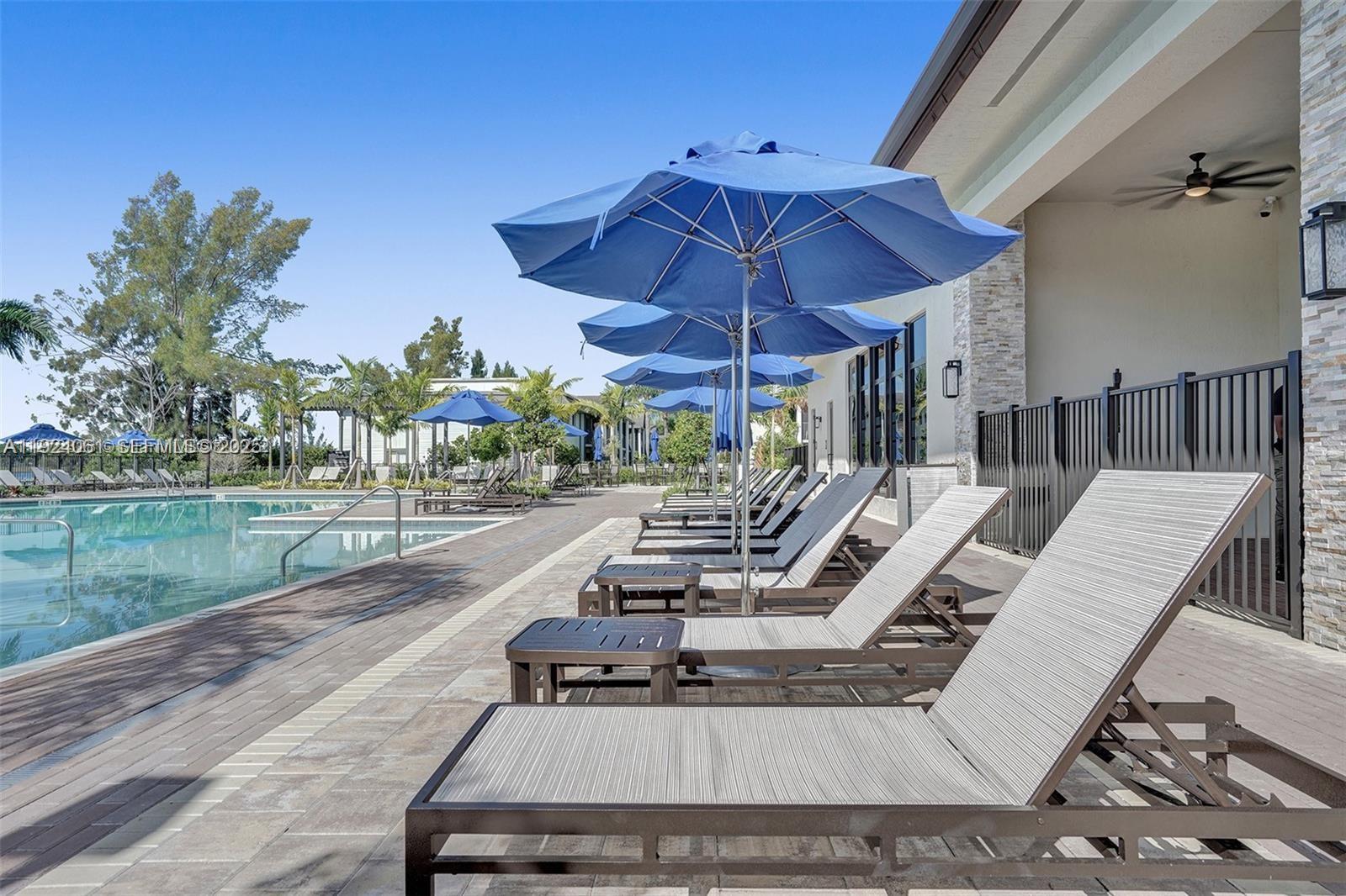 268 Northeast 210th Way Miami, FL 33179 - Photo 76 of 98 a view of a patio with a table chairs and a umbrella