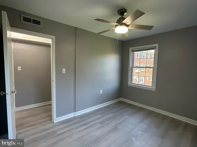 wooden floor in an empty room with a window