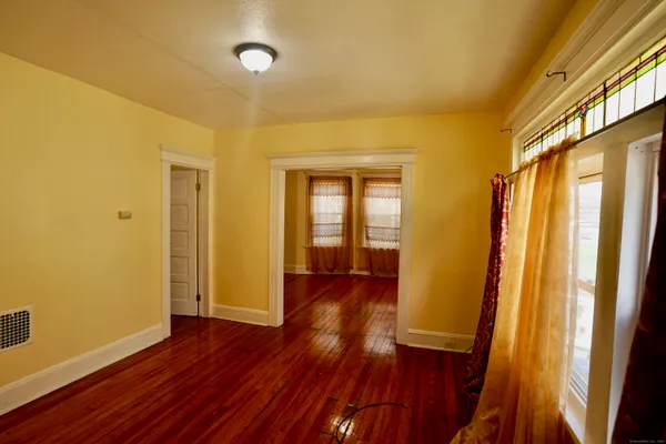 a view of hallway with wooden floor and stairs