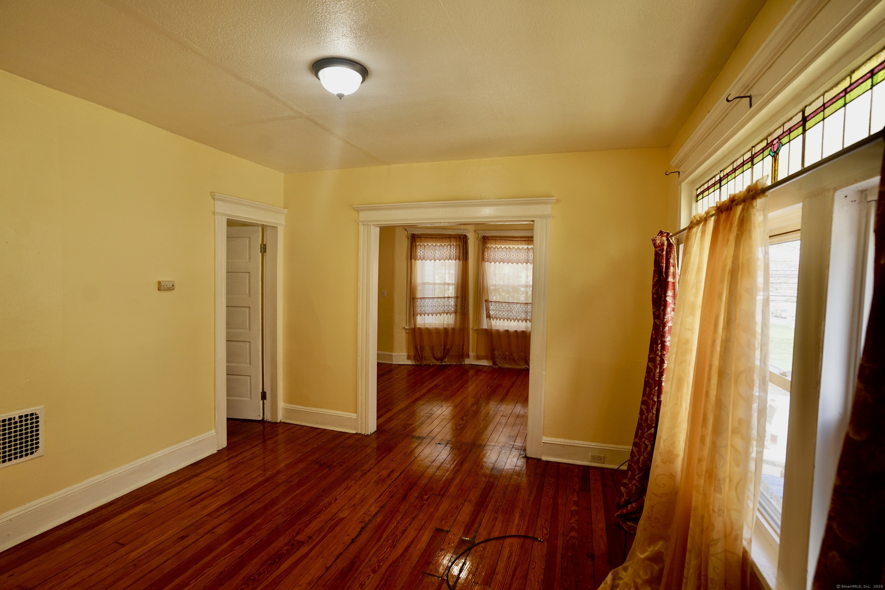 744 Boston Avenue Bridgeport, CT 06610 - Photo 4 of 10 a view of hallway with wooden floor and stairs