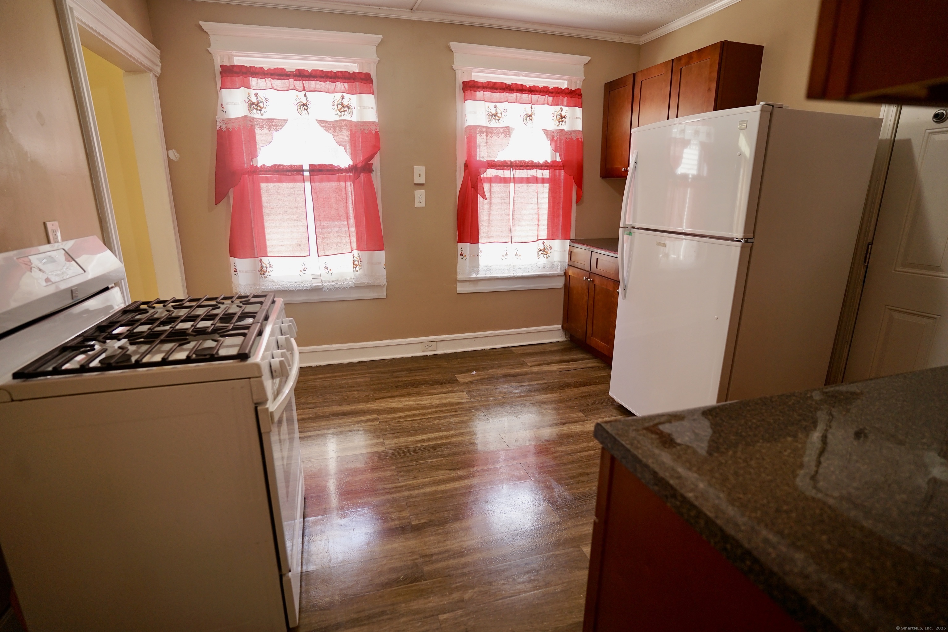 744 Boston Avenue Bridgeport, CT 06610 - Photo 6 of 10 a kitchen with stainless steel appliances a refrigerator sink and wooden floor