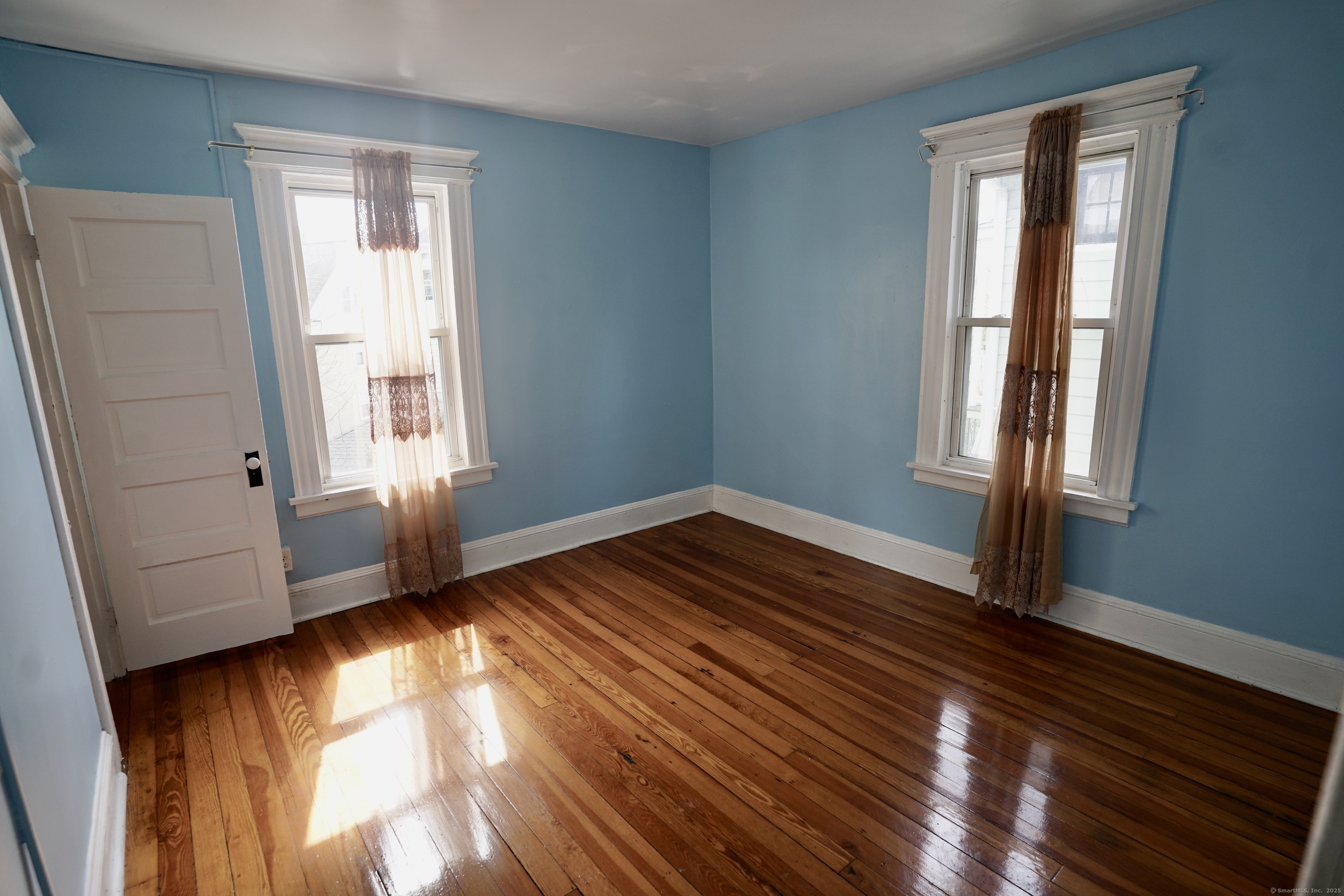 744 Boston Avenue Bridgeport, CT 06610 - Photo 8 of 10 a view of empty room with wooden floor and fan