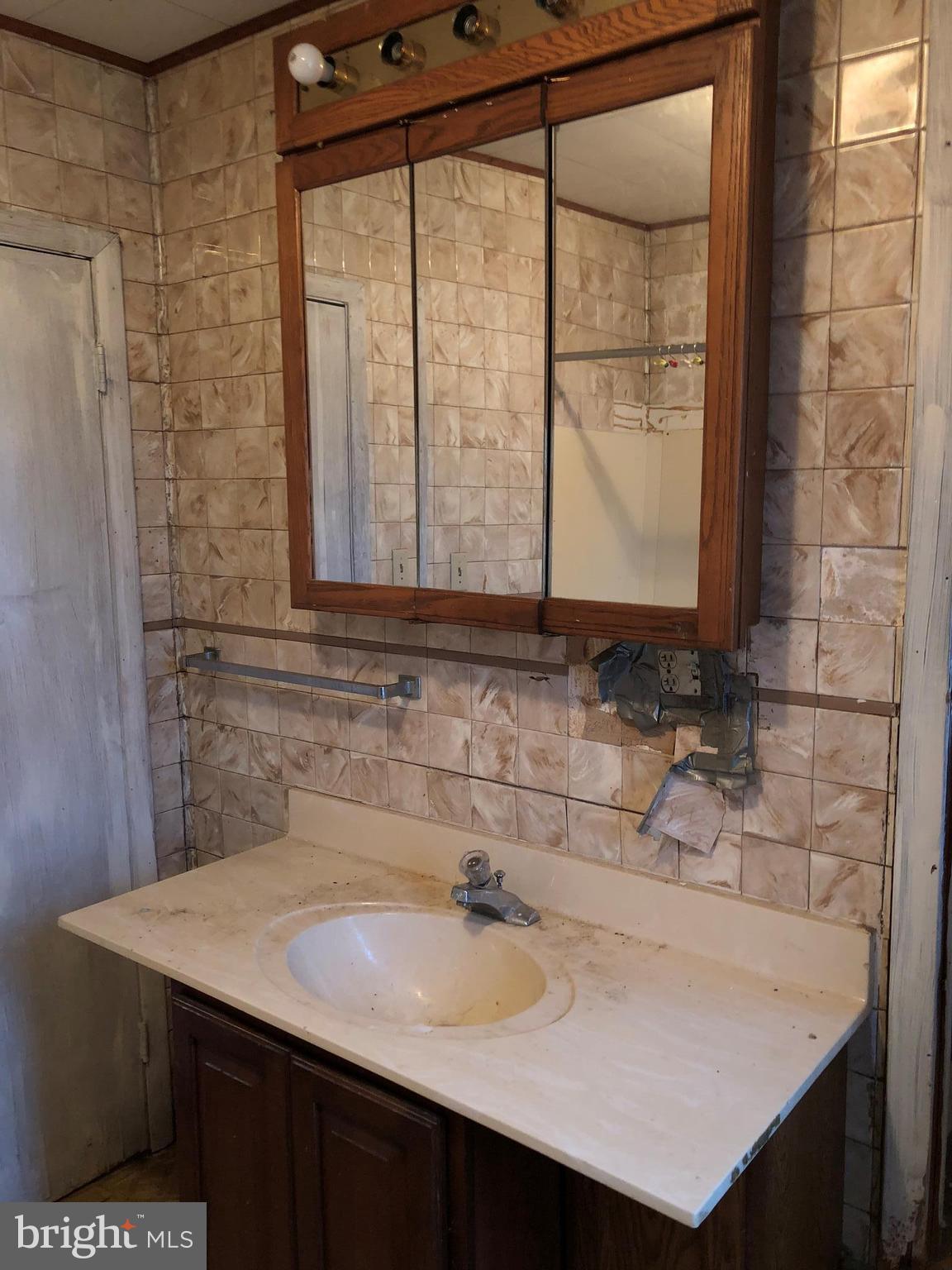 21005 Reno Monument Road Boonsboro, MD 21713 - Photo 23 of 30 a bathroom with a sink and a mirror