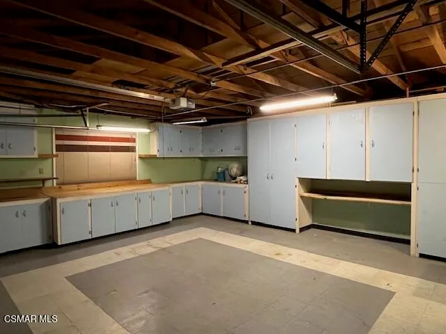 a view of a kitchen with wooden cabinets
