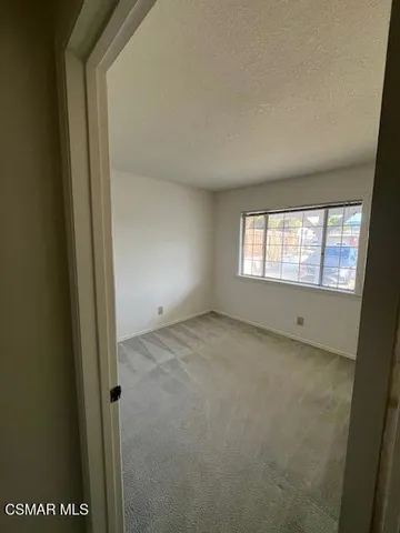 a view of an empty room and a window