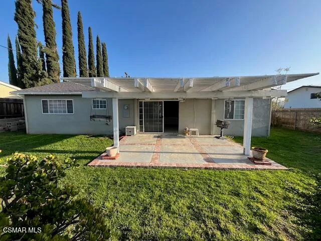 a view of house with yard and outdoor seating