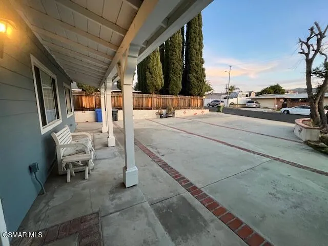 a view of a patio with a table and chairs