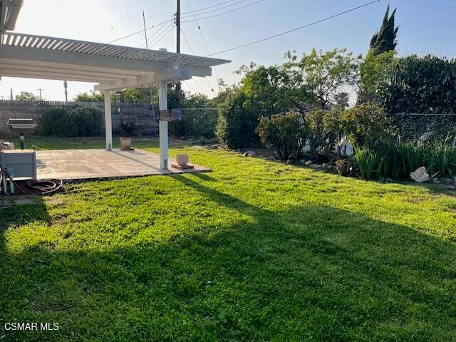 a view of a house with a yard and sitting area