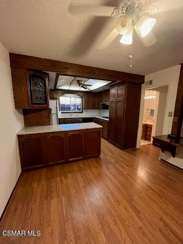 a view of a room with wooden floor
