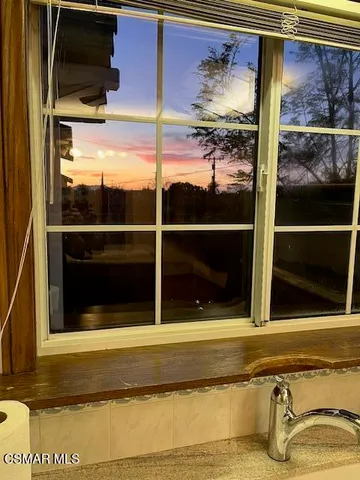 a view of a door of the house and a window
