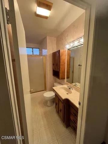 a bathroom with a sink a mirror and a shower