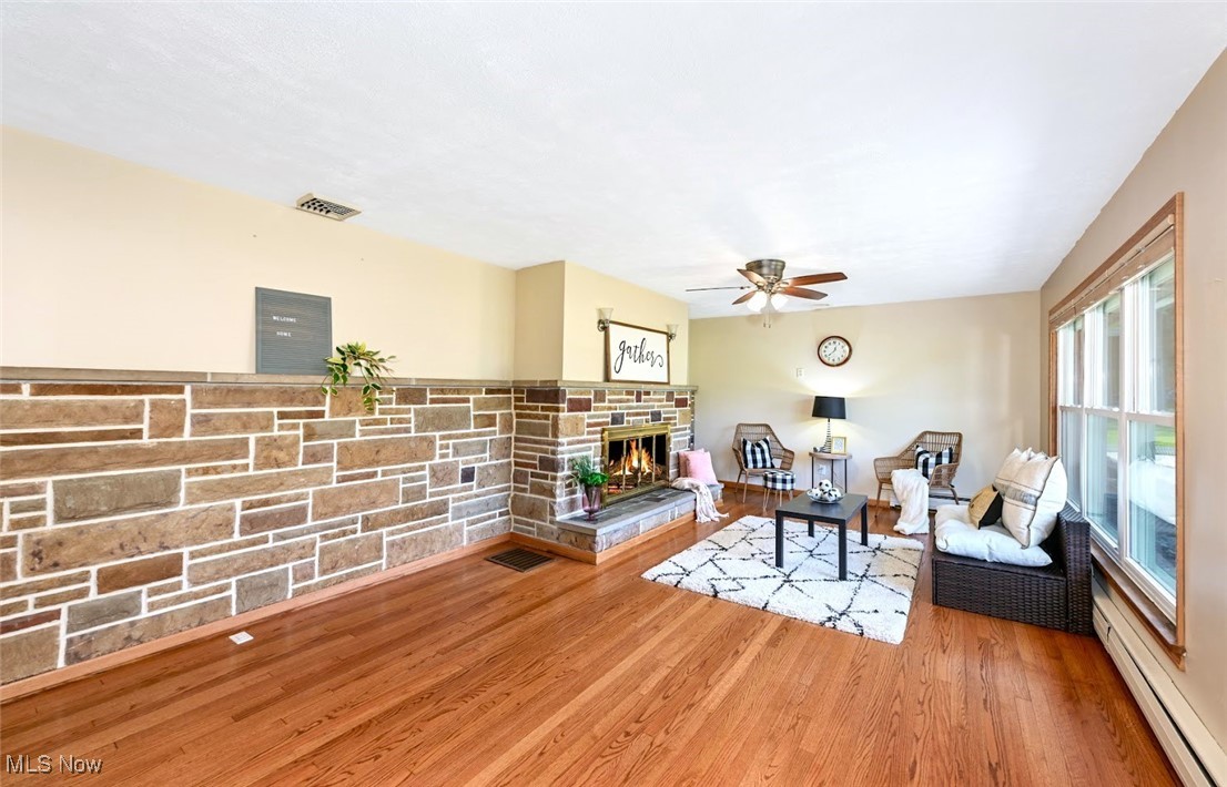 4597 Rock Cut Road Barberton, OH 44203 - Photo 8 of 44 *LIVING RM W/REFINISHED HARDWOOD FLOOR, WALL TO WALL STONEWORK, STONE FIREPLACE, CEILING FAN AND TRIPLE WINDOWS ~