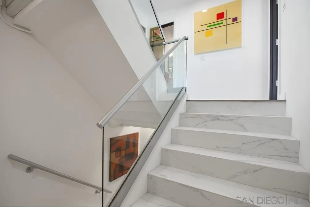 2331 Caringa Way, Unit 38 Carlsbad, CA 92009 - Photo 13 of 26 a view of staircase with white walls and railing