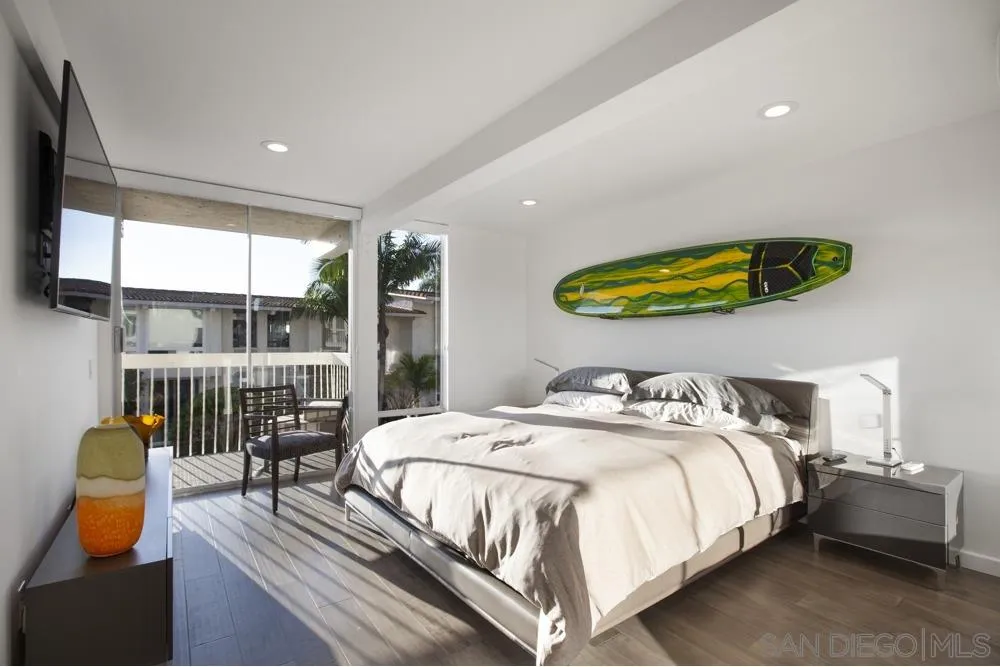 2331 Caringa Way, Unit 38 Carlsbad, CA 92009 - Photo 14 of 26 a bedroom with a bed a couch and a large window