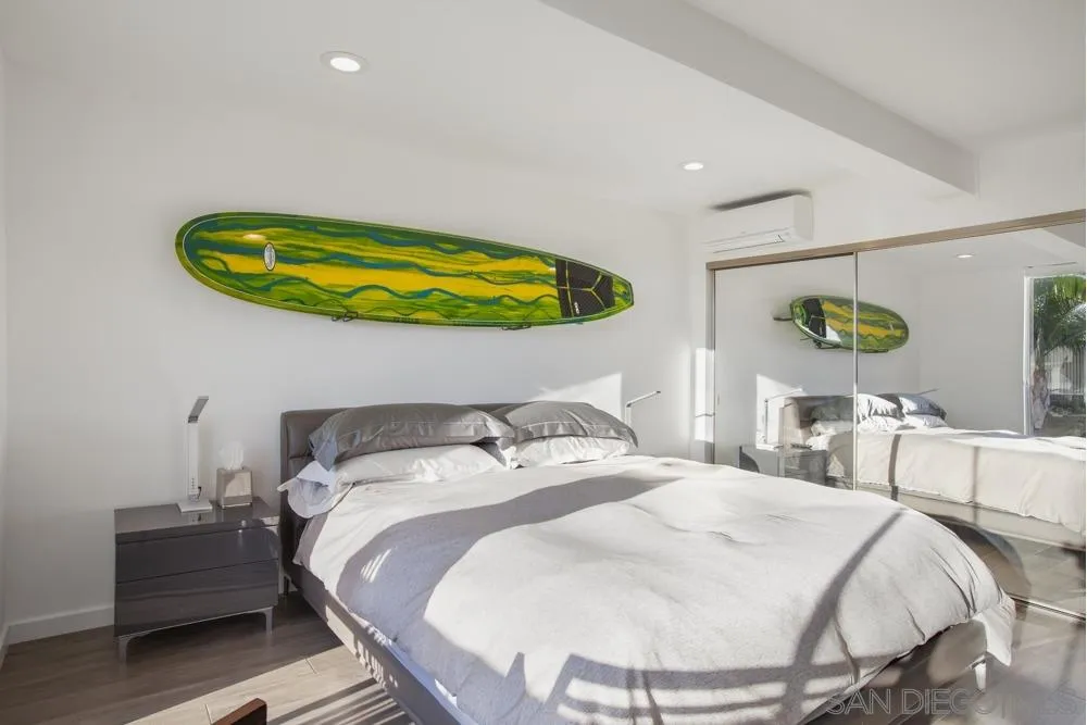 2331 Caringa Way, Unit 38 Carlsbad, CA 92009 - Photo 15 of 26 a bedroom with a bed and ceiling fan