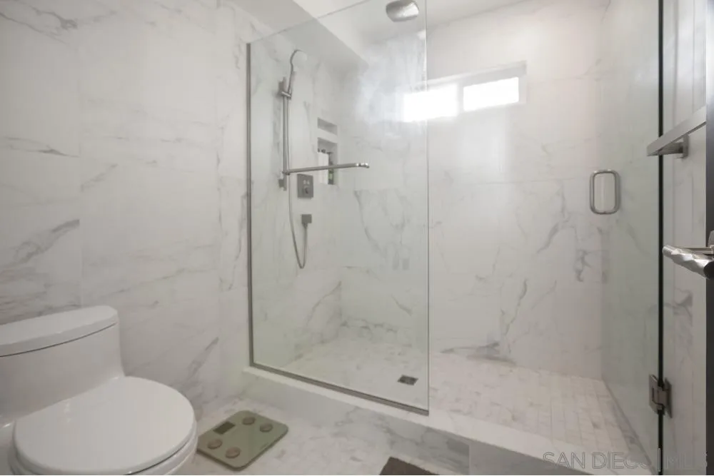 2331 Caringa Way, Unit 38 Carlsbad, CA 92009 - Photo 16 of 26 a white toilet next to a bathroom