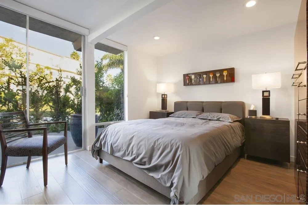 2331 Caringa Way, Unit 38 Carlsbad, CA 92009 - Photo 17 of 26 a bedroom with a large bed and a large window