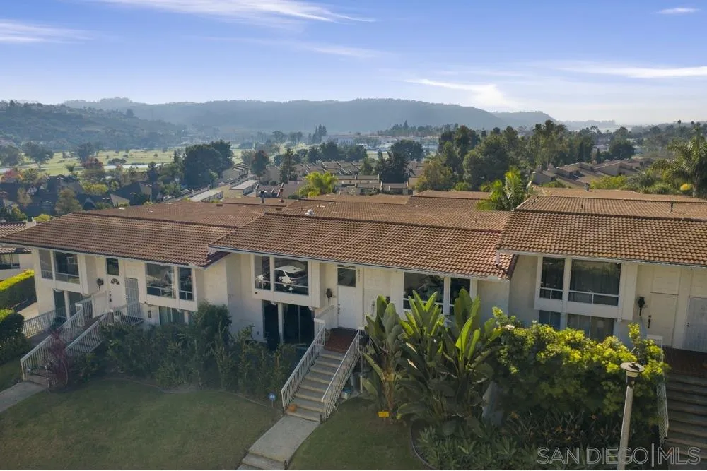 2331 Caringa Way, Unit 38 Carlsbad, CA 92009 - Photo 2 of 26 a aerial view of a house with a yard and balcony