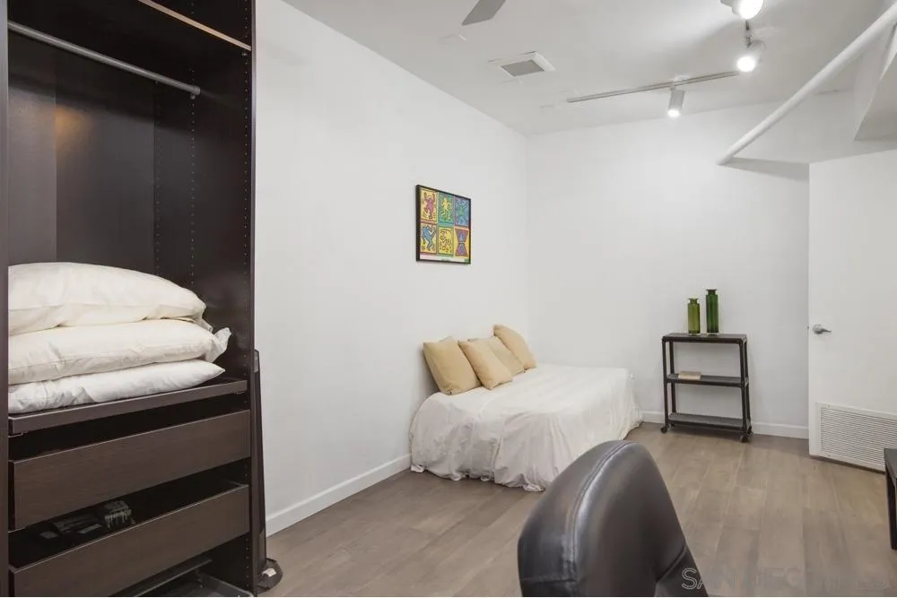 2331 Caringa Way, Unit 38 Carlsbad, CA 92009 - Photo 22 of 26 a bedroom with a bed and a chair